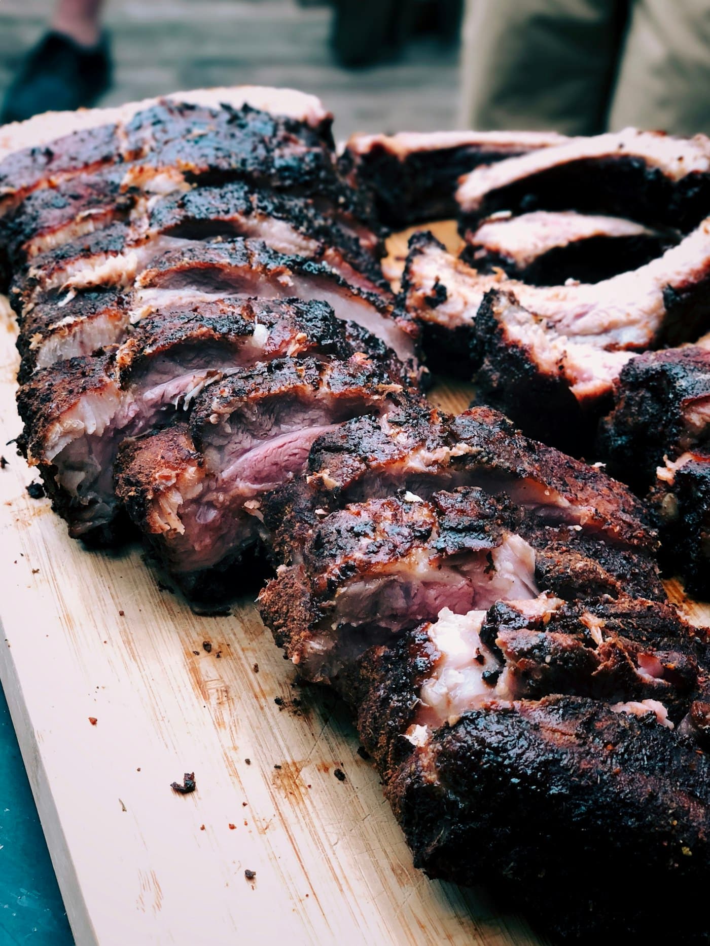Charred, hand-rubbed ribs resting on a board